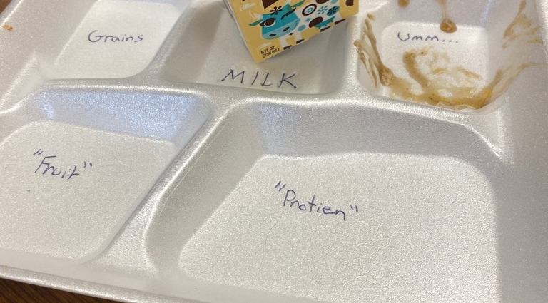 typical school lunch styrofoam tray with milk carton and straw