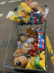 cart full of groceries in a parking lot